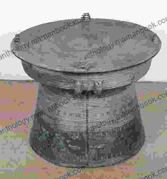 A Large Bronze Drum With Intricate Designs And Patterns, Standing On A Wooden Stand. Bronze Drum Phong Nguyen